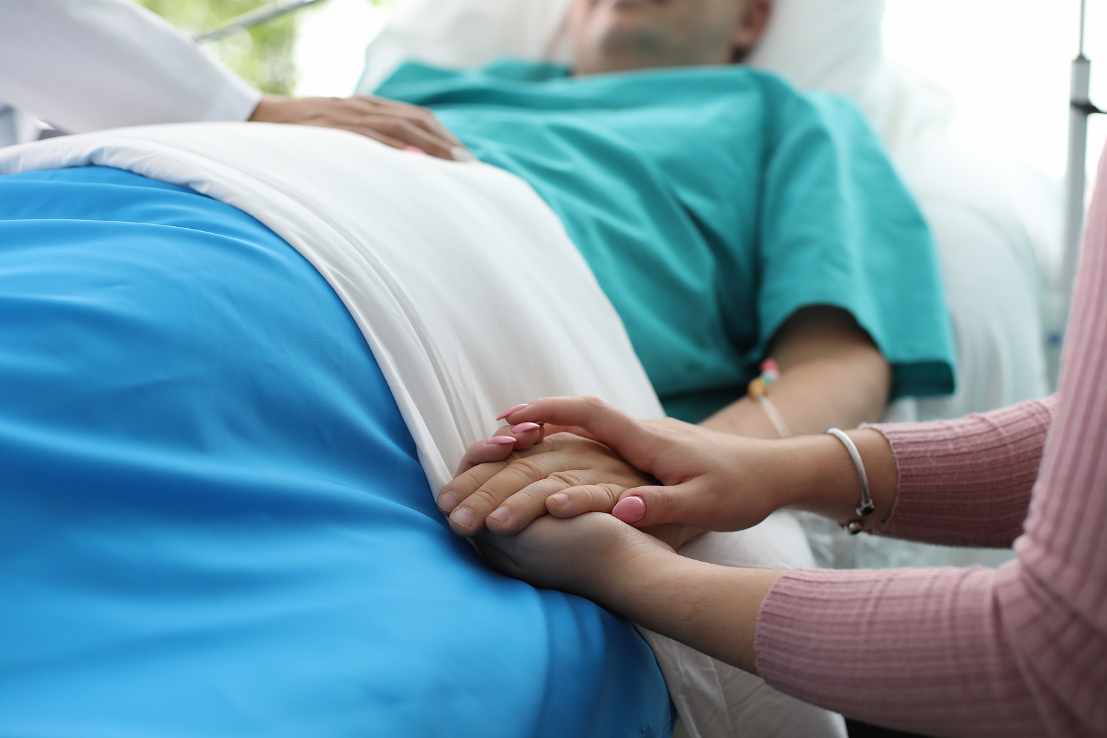 Close-up View Of Sick Person And Family Member Supporting And Wi