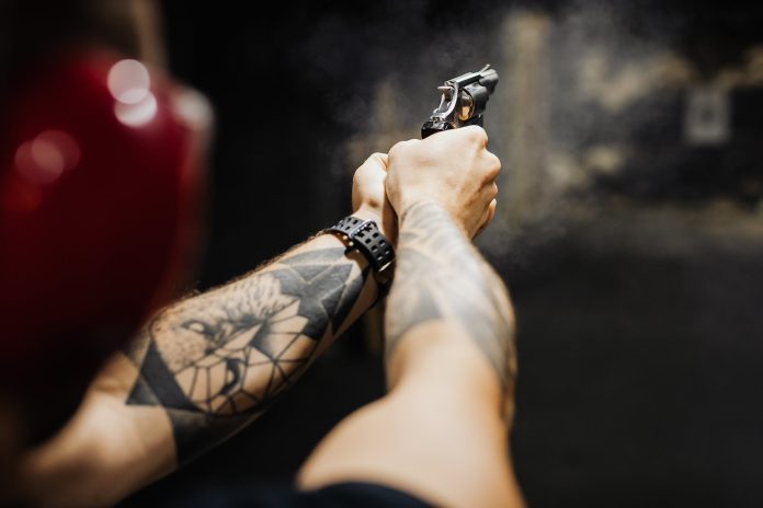 pexels-photo-5202388 a person holding black and silver revolver pistol