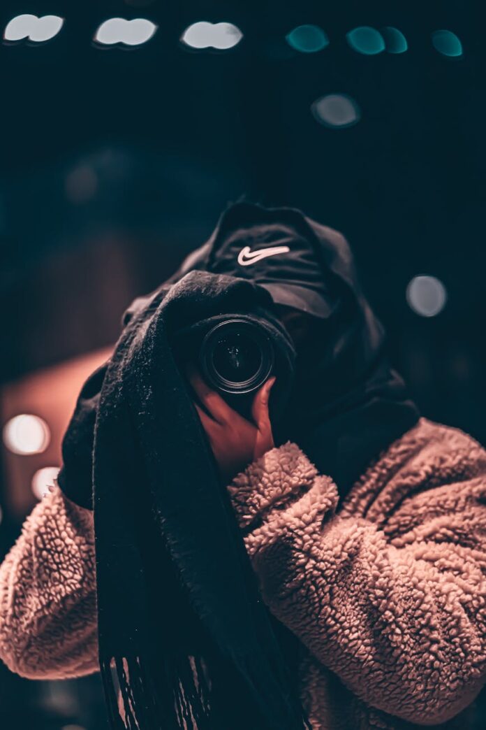 pexels-photo-5707182 faceless photographer in warm clothes taking photo