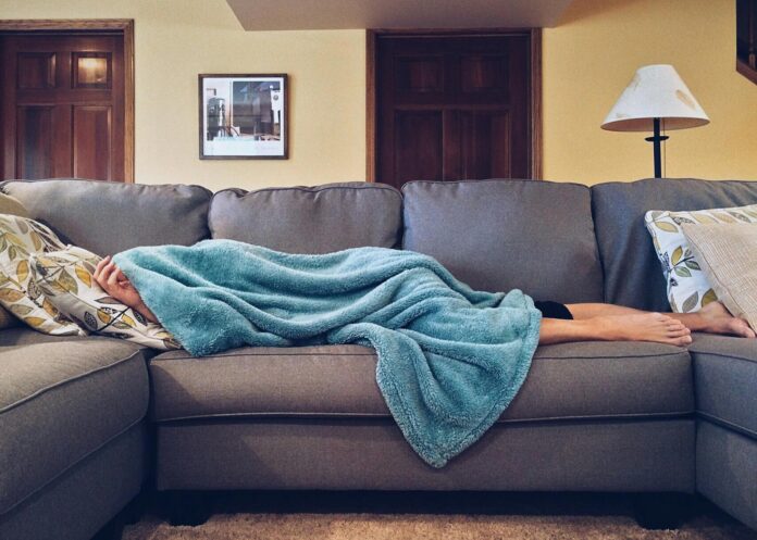 pexels-photo-269141 person lying on sofa