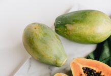 photo of sliced papaya on top of marbled surface