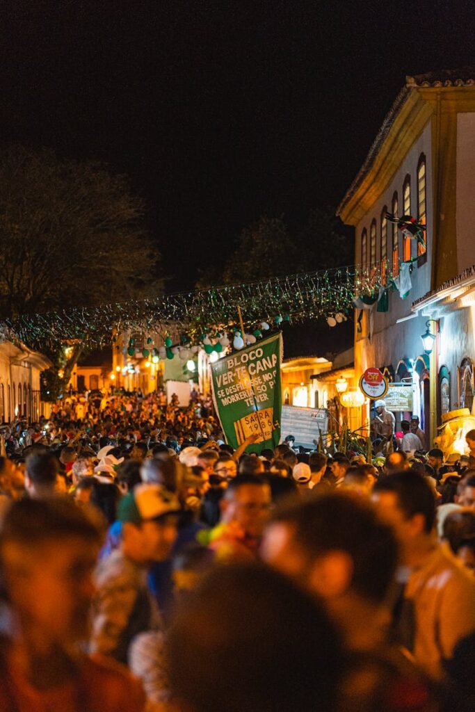 view of a crowded street in city at night during a festival