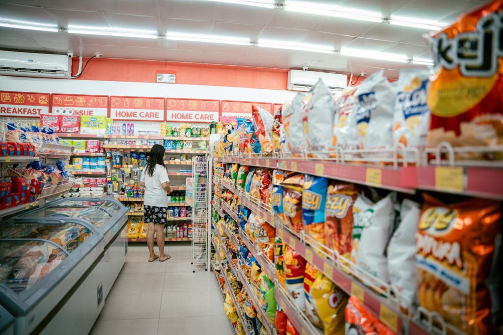 woman standing at end of aisle in supermarket