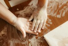 creative child painting with hands