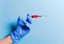 person holding syringe