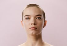 woman in blue tube dress with green gloves on her head