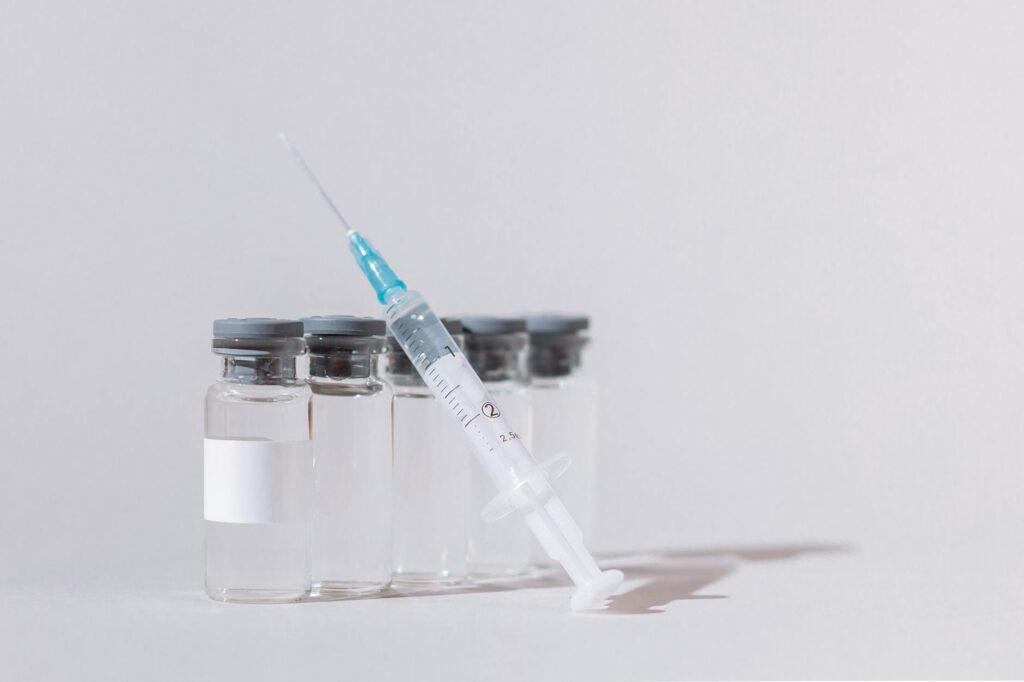 covid vaccine bottles and syringe