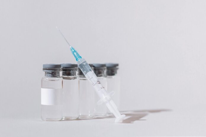 covid vaccine bottles and syringe