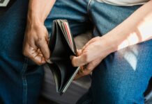 man looking at an empty wallet