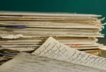 white stacked worksheets on table