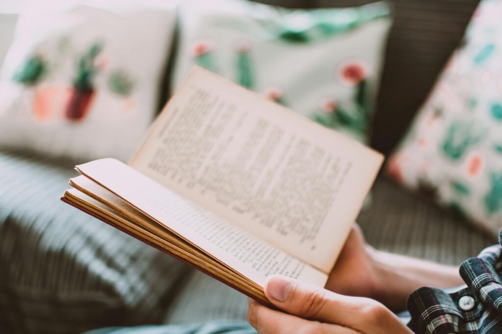 close up photo of person holding book
