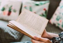 close up photo of person holding book