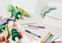 kid on white table painting