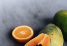 photo of sliced papaya beside sliced lime