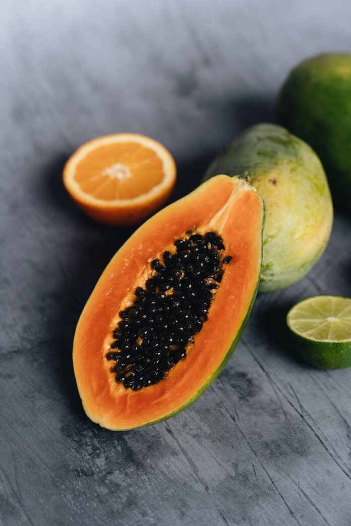 photo of sliced papaya beside sliced lime