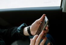 person in black jacket holding smartphone