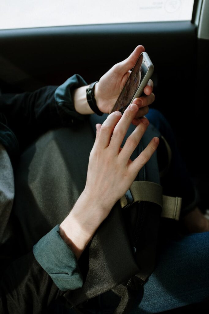 person in black jacket holding smartphone