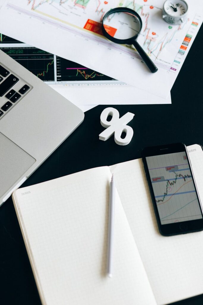 black smartphone on white notebook