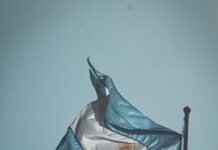 flag of argentina swaying by the wind under blue sky