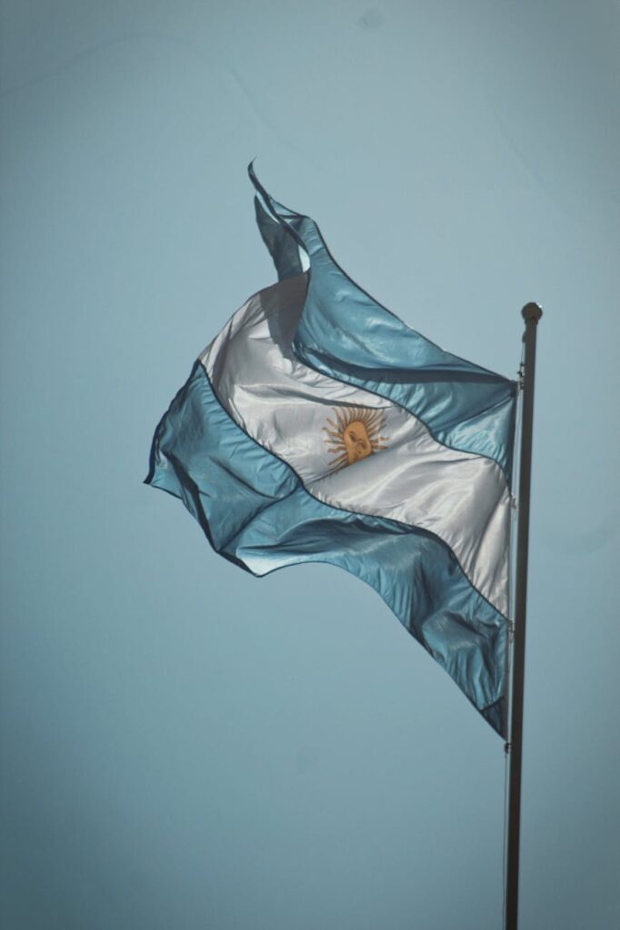 flag of argentina swaying by the wind under blue sky