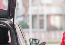 close up of a person refueling the car at a gas station