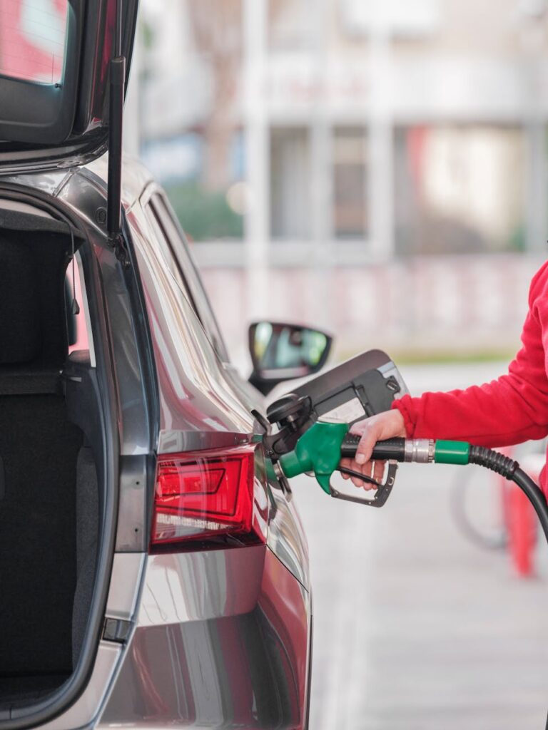 close up of a person refueling the car at a gas station
