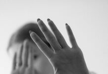 monochrome hands blocking camera close up