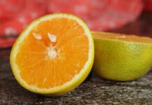 close up of freshly sliced orange on granite surface