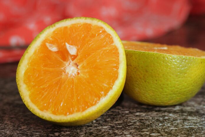 close up of freshly sliced orange on granite surface