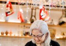 elderly woman working at a cozy coffee shop counter