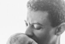 man kissing his baby