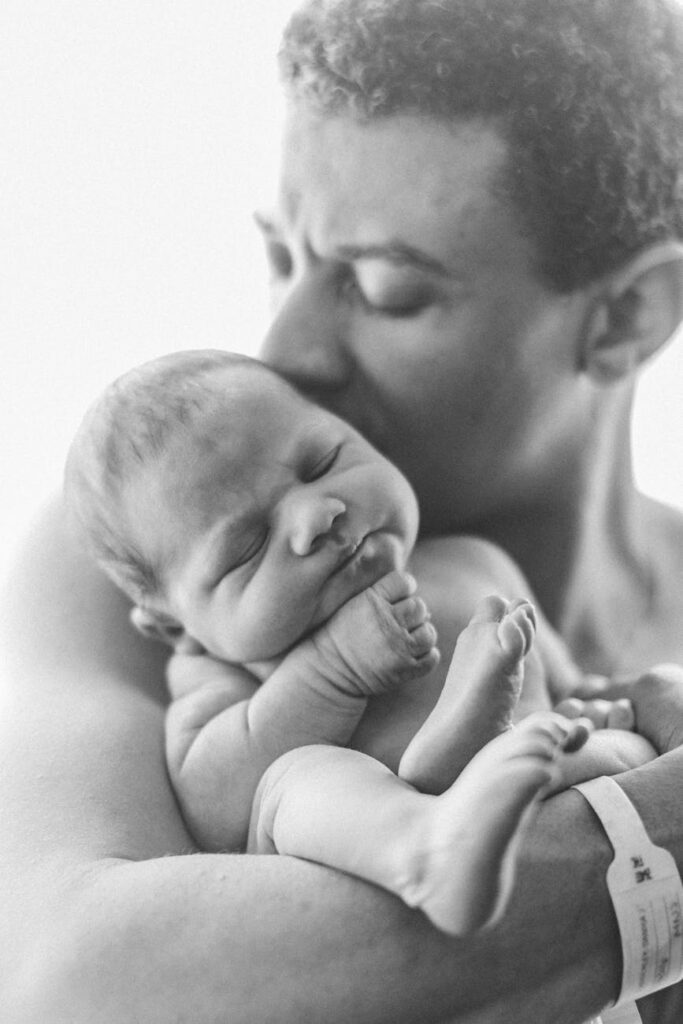 man kissing his baby