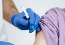 close up shot of a health worker injecting a vaccine on a patient