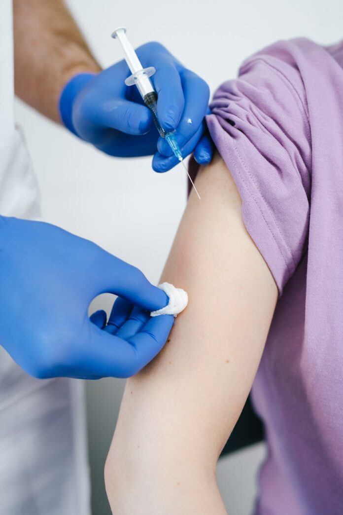 close up shot of a health worker injecting a vaccine on a patient