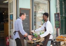 men arranging the fruits and vegetables