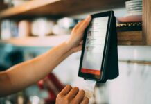person holding a payment digital device