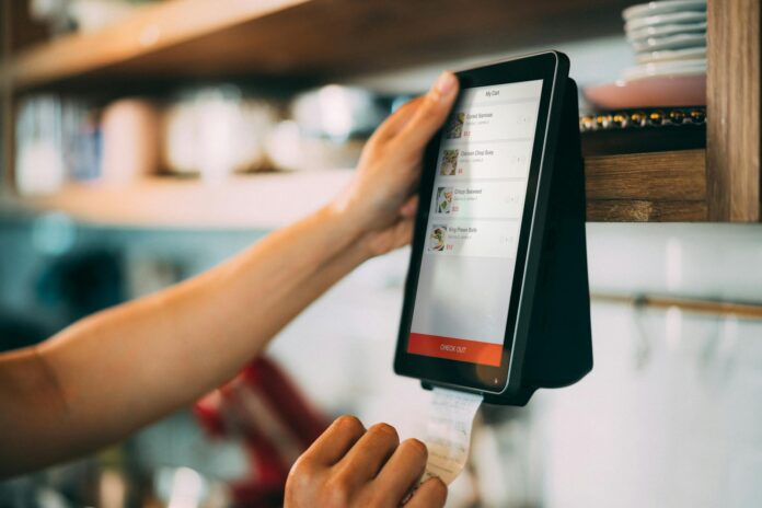 person holding a payment digital device