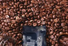 coffee bag surrounded by roasted coffee beans