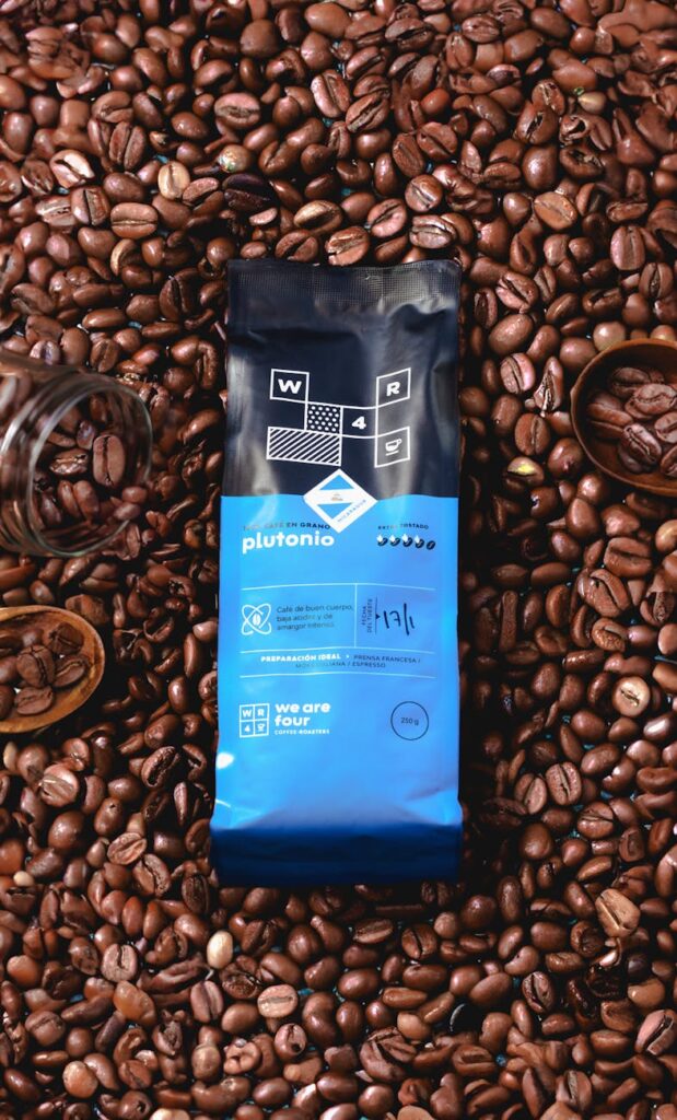 coffee bag surrounded by roasted coffee beans