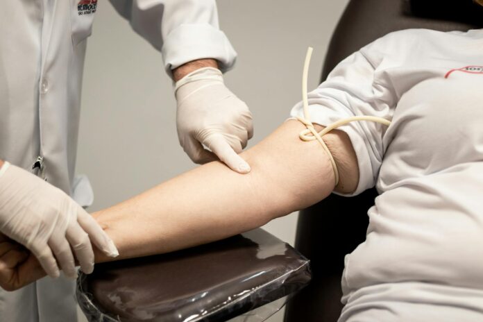 a medical professional wearing latex gloves holding a person s hand