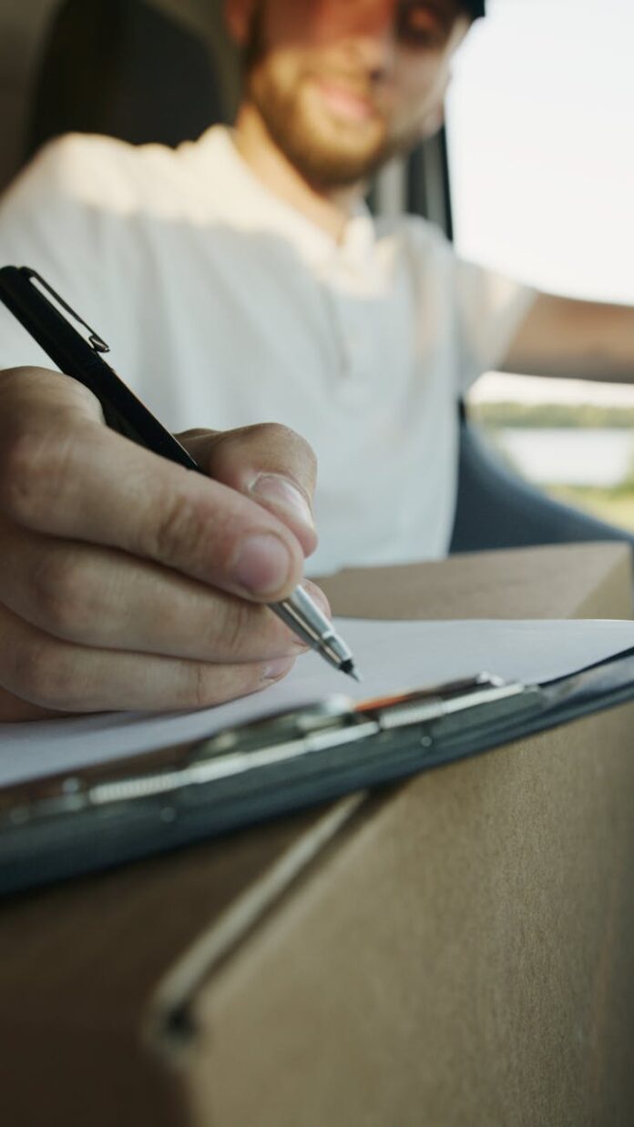 pexels-photo-5025501 close up shot of a person writing on paper