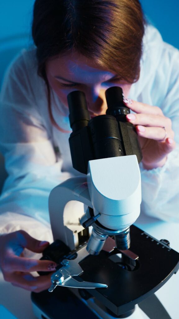 a woman looking through the microscope