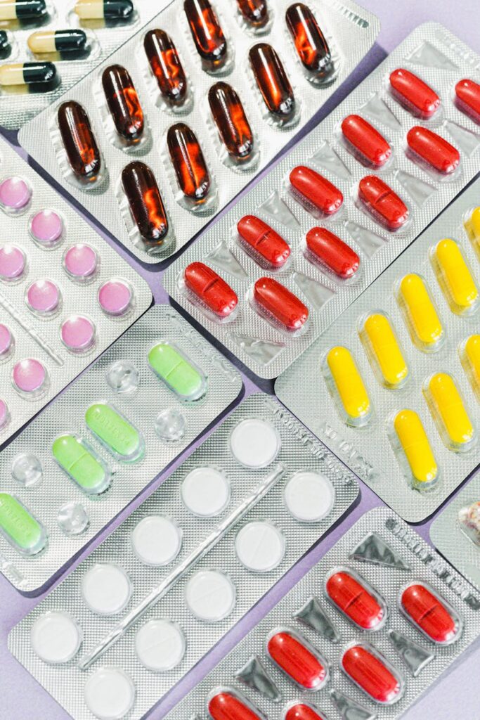 pink and yellow medication pill blister pack