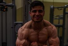 bodybuilder man flexing his muscles in a gym