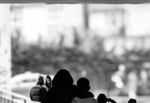 back view of boys hugging and walking