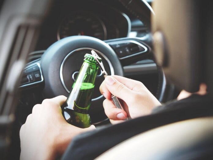 pexels-photo-288476 person opening bottle on car