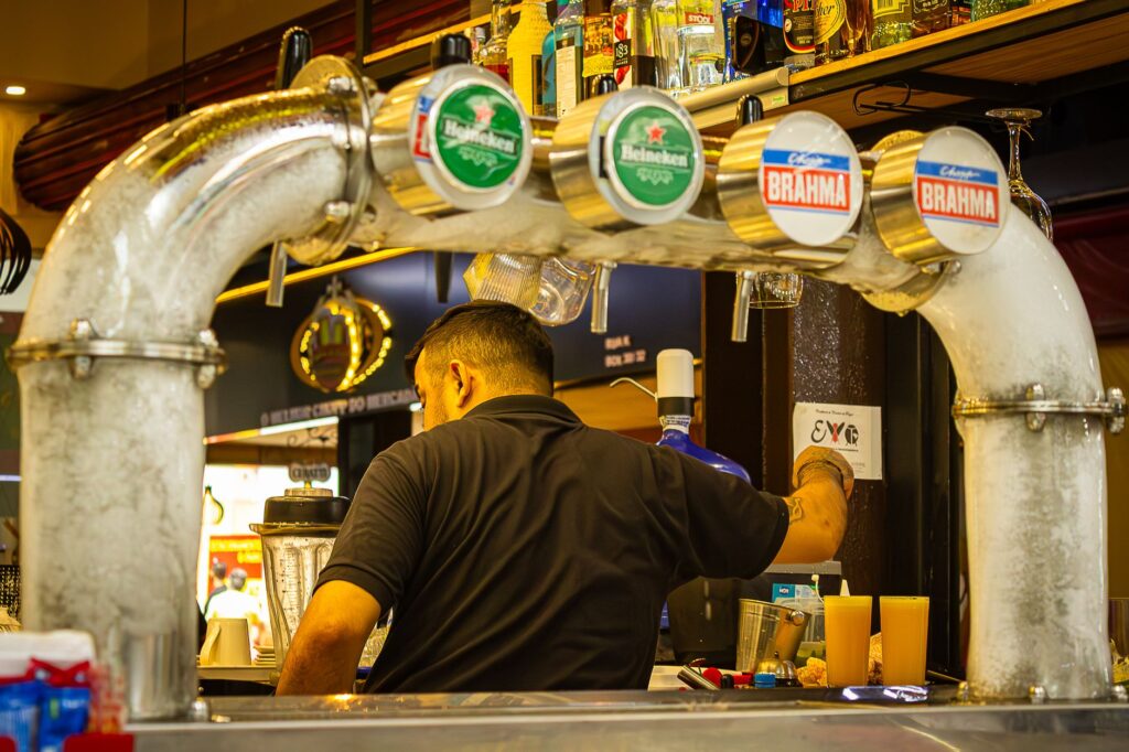 bartender serving drinks at a busy bar