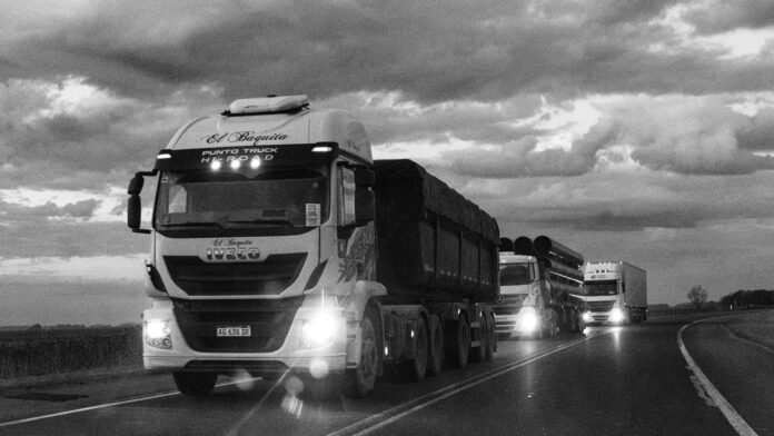 pexels-photo-33462124 monochrome trucks on argentinian highway at dusk