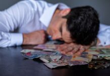 man resting on table with argentine pesos