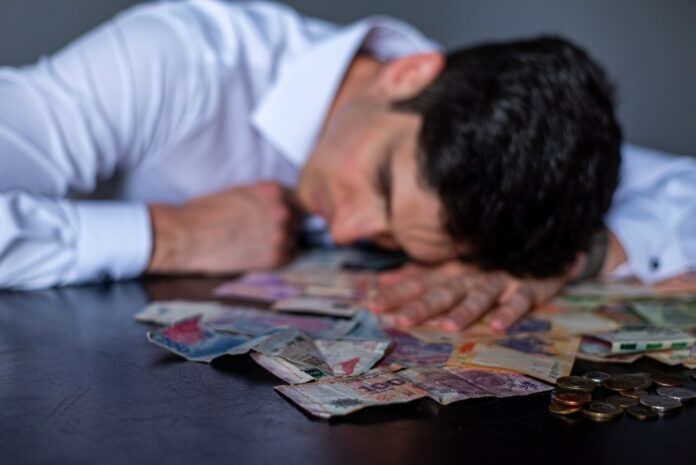man resting on table with argentine pesos